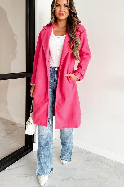 Woman in a blush pink coat with jeans