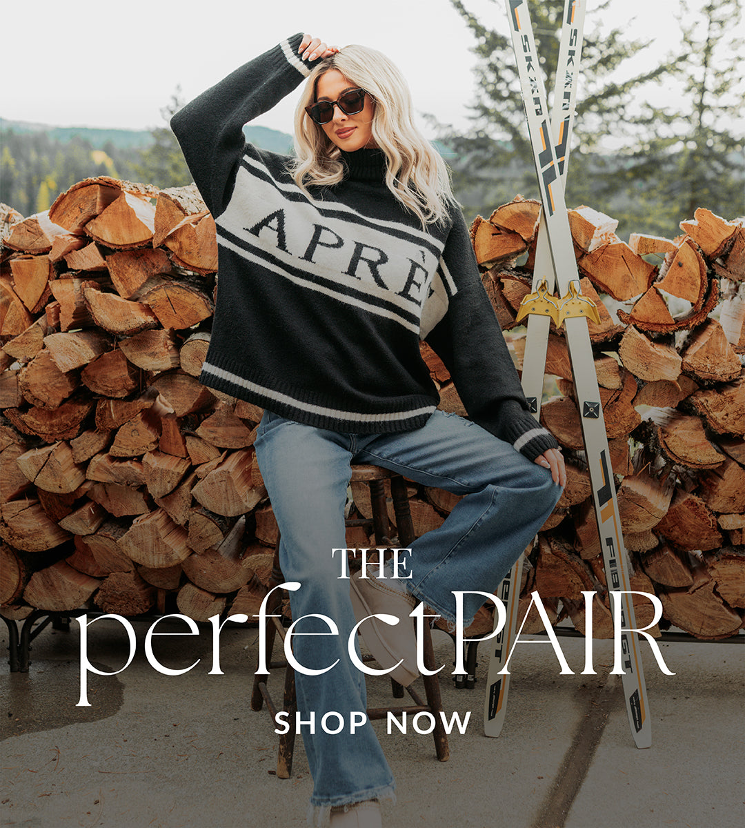 Woman in a sweater with skis and woodpile, promoting 'The perfectPAIR'.