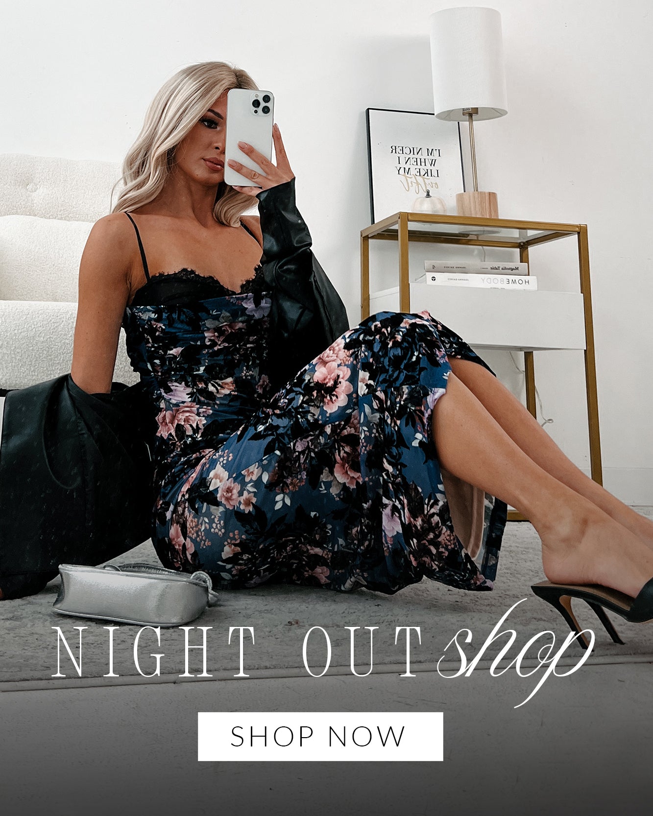 Photo of model taking a selfie in a navy floral lace dress. Headline says "Night Out Shop" Call to Action says "Shop Now" and links to the Night Out collection.