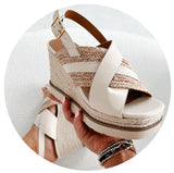 Photo of a jute and white faux leather wedge sandal. Links to the shoe collection.
