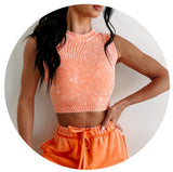 Model wearing a bright orange brami tank and orange sweatpants. Links to the Tops Collection.