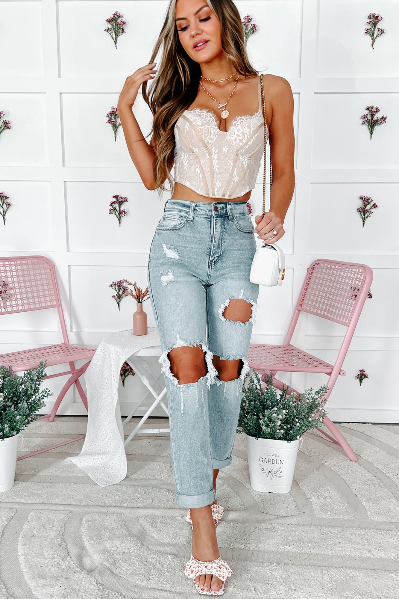 white corset top with distressed denim jeans outfit